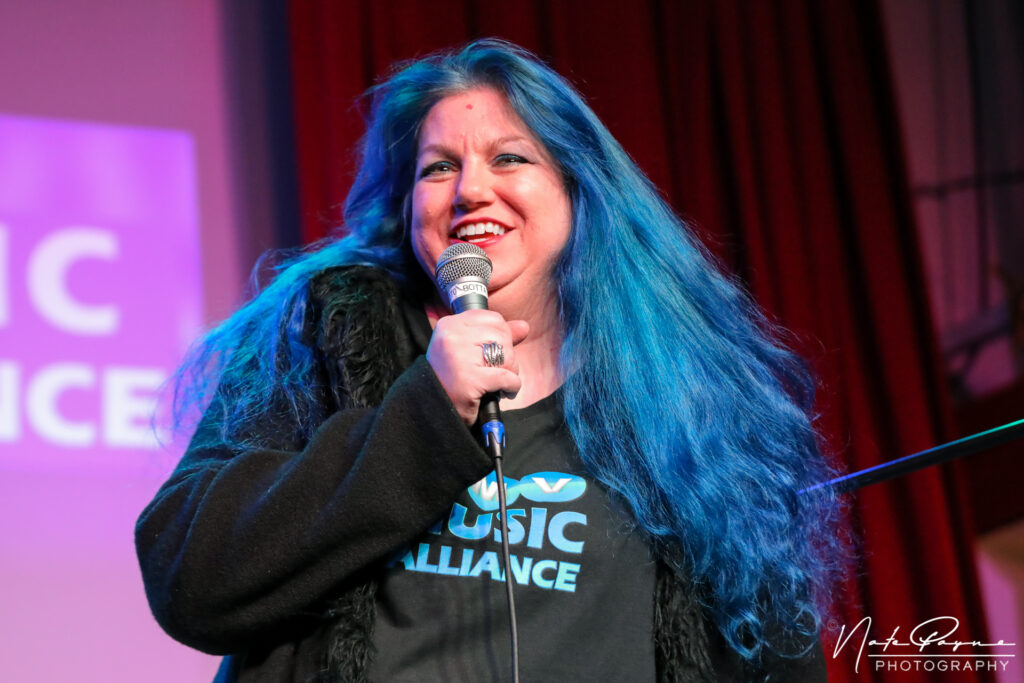 Dani Weymouth speaking at DMV Music Benefits All Showcase at Songbyrd Music House